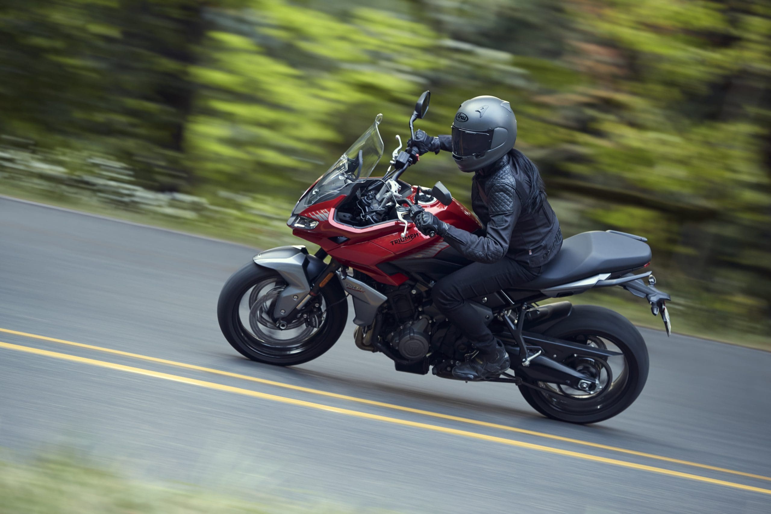 A shot of a rider cornering on the new Triumph Tiger Sport 660 in the canyons