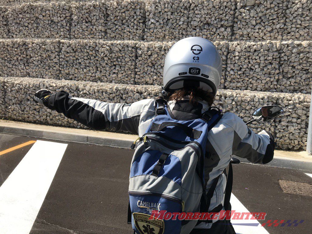 Victoria Zandonella gives hand signal to allow motorcyclists to pass