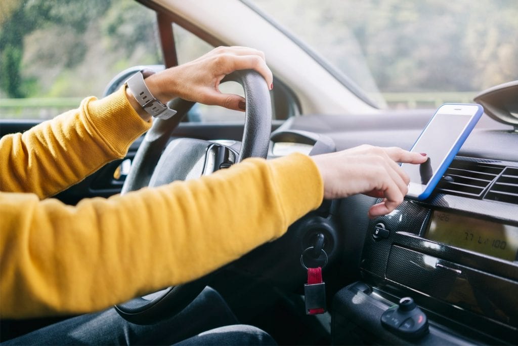 driver using hands-free system related to Drivewell, owned by CMT