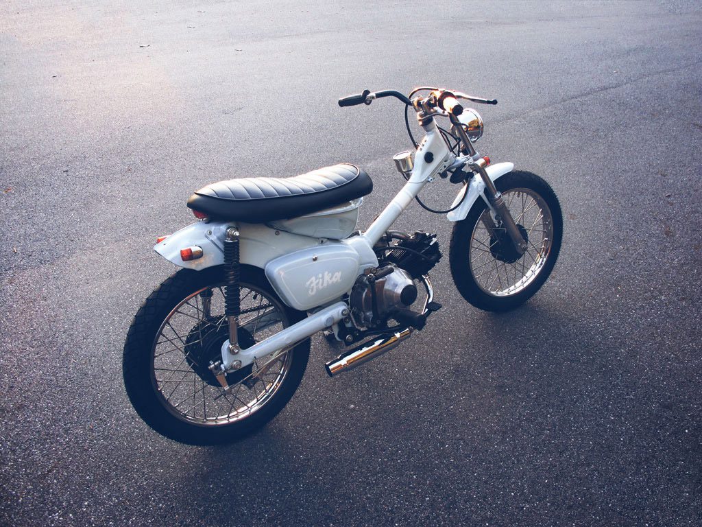 A custom Honda CT110 'Postie' bike at dusk