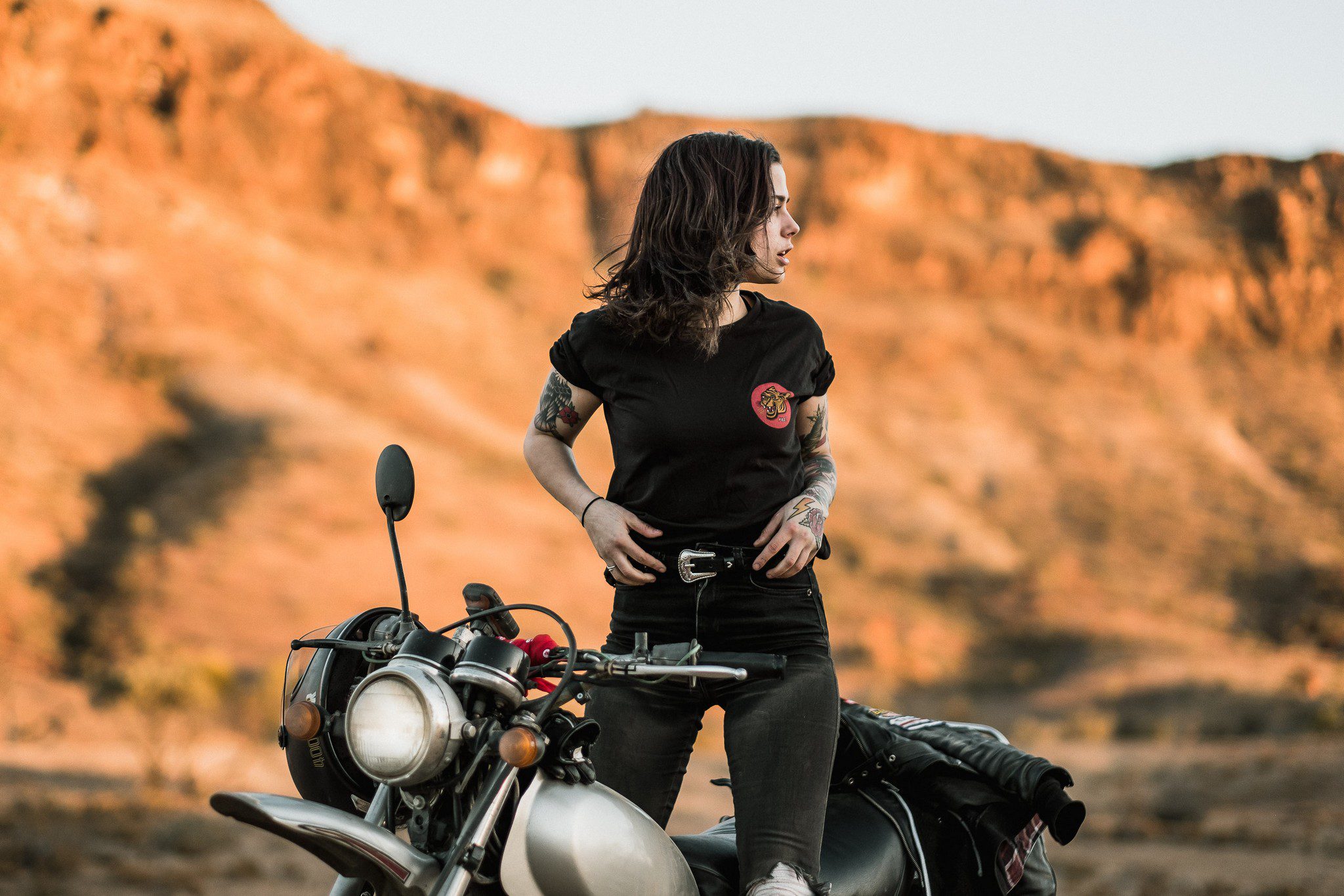  Woman on a motorcycle at dusk in a Tasmanian field