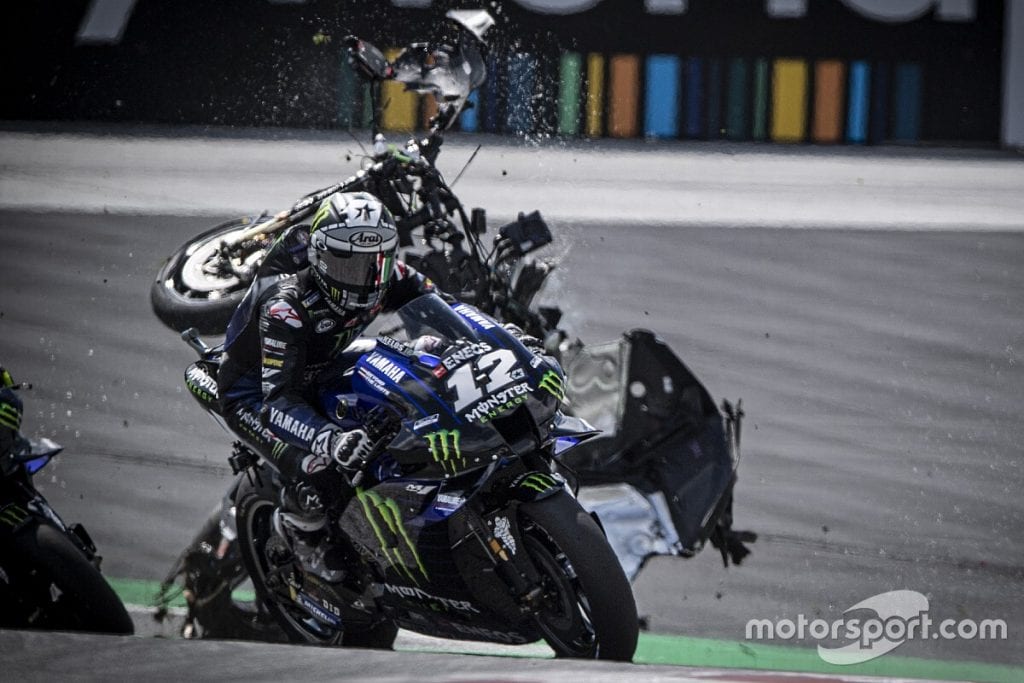 Maverick Vinales next to his bike from Yamaha Racing