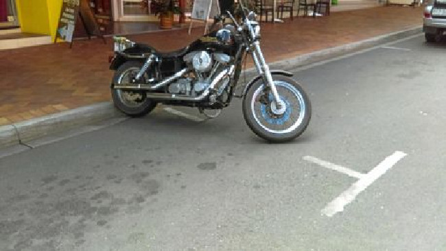 Lance was fined for parking his Harley between two car parking bays flexible