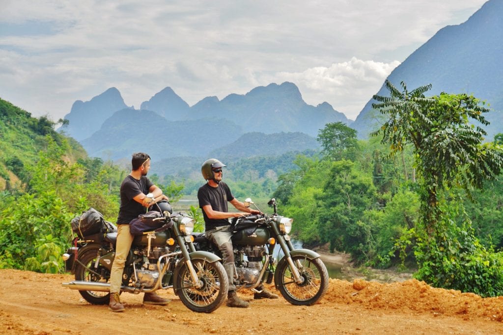 Two riders enjoy the view in Laos
