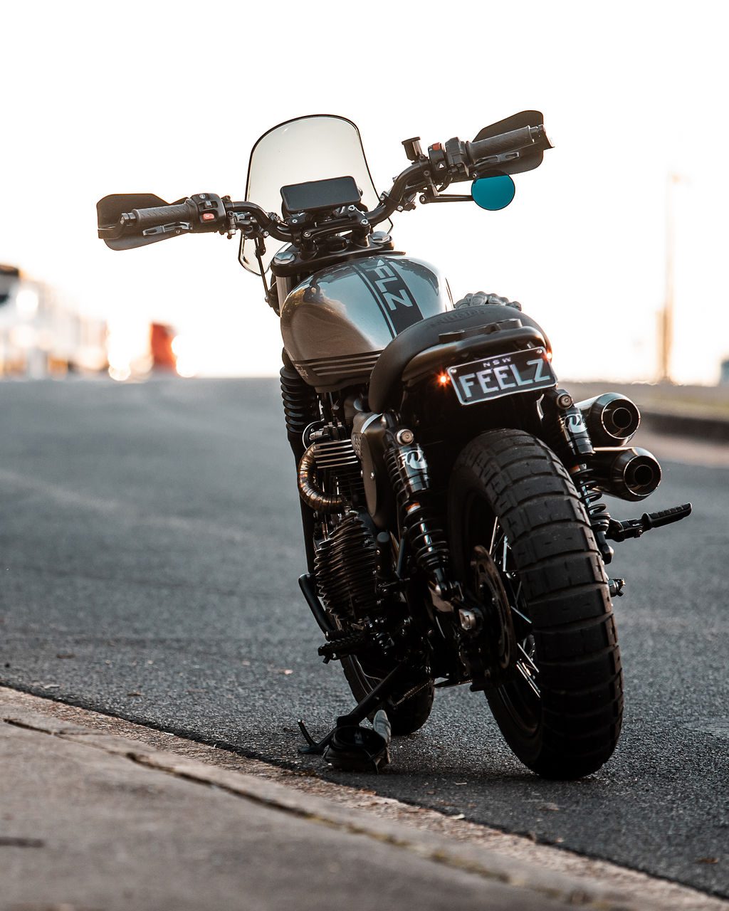 Triumph Scrambler Motorcycle at dusk parked by the side of the road in Sydney