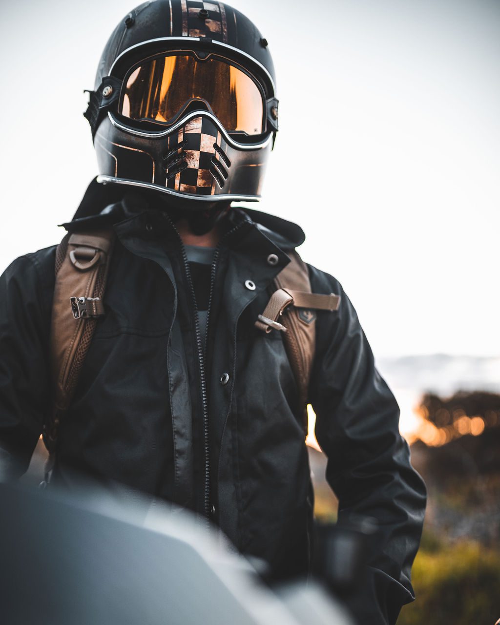 Motorcyclists wearing helmet and jacket at dusk in Sydney