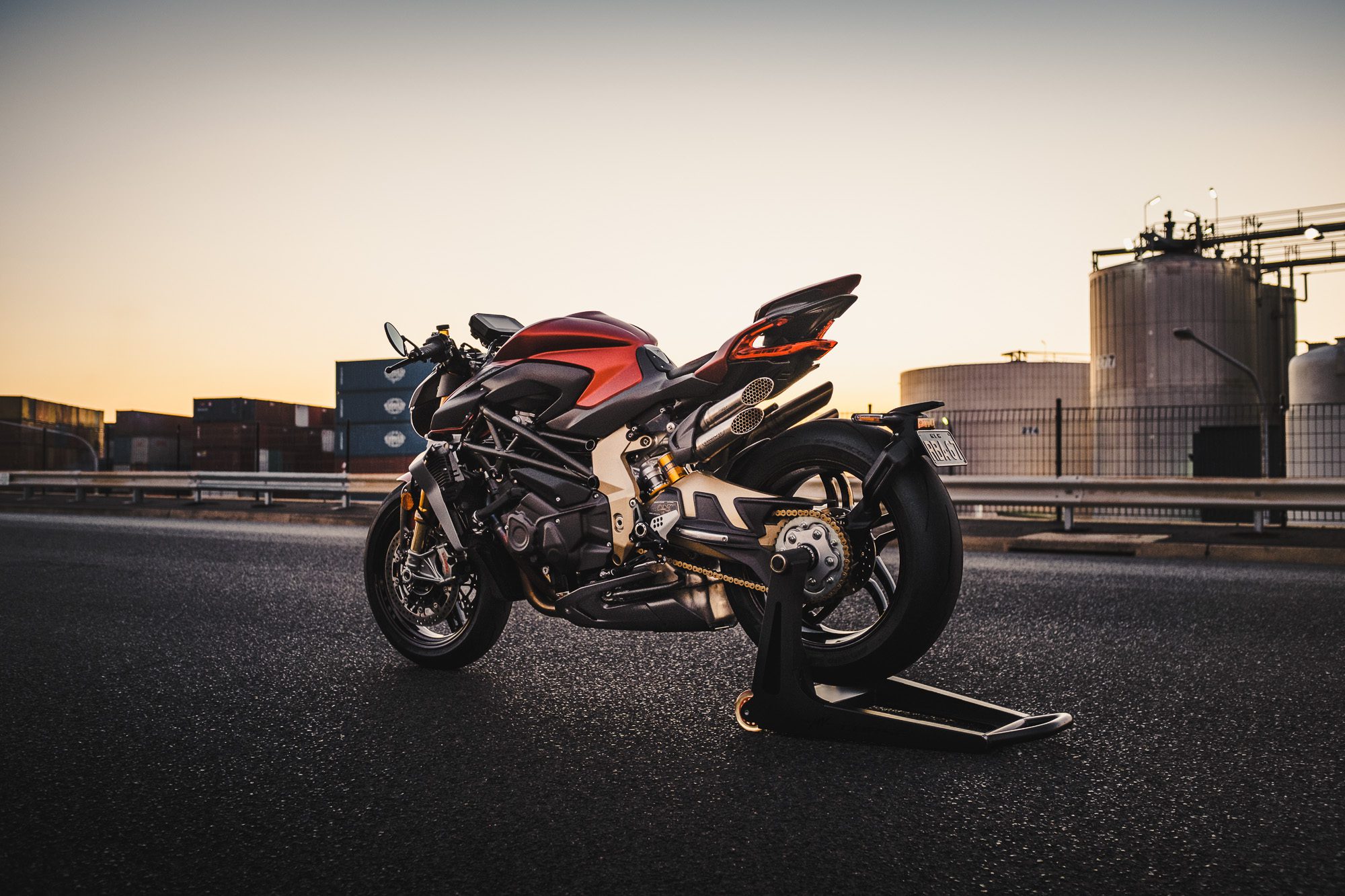 An MV Agusta Brutale motorcycle on an industrial road at sunset