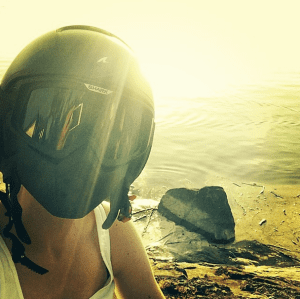 sunset photo of female biker wearing shark raw helmet
