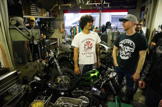 Kaichihiroh Kuosu talks to Aussie journos in his cramped workshop - custom bagger