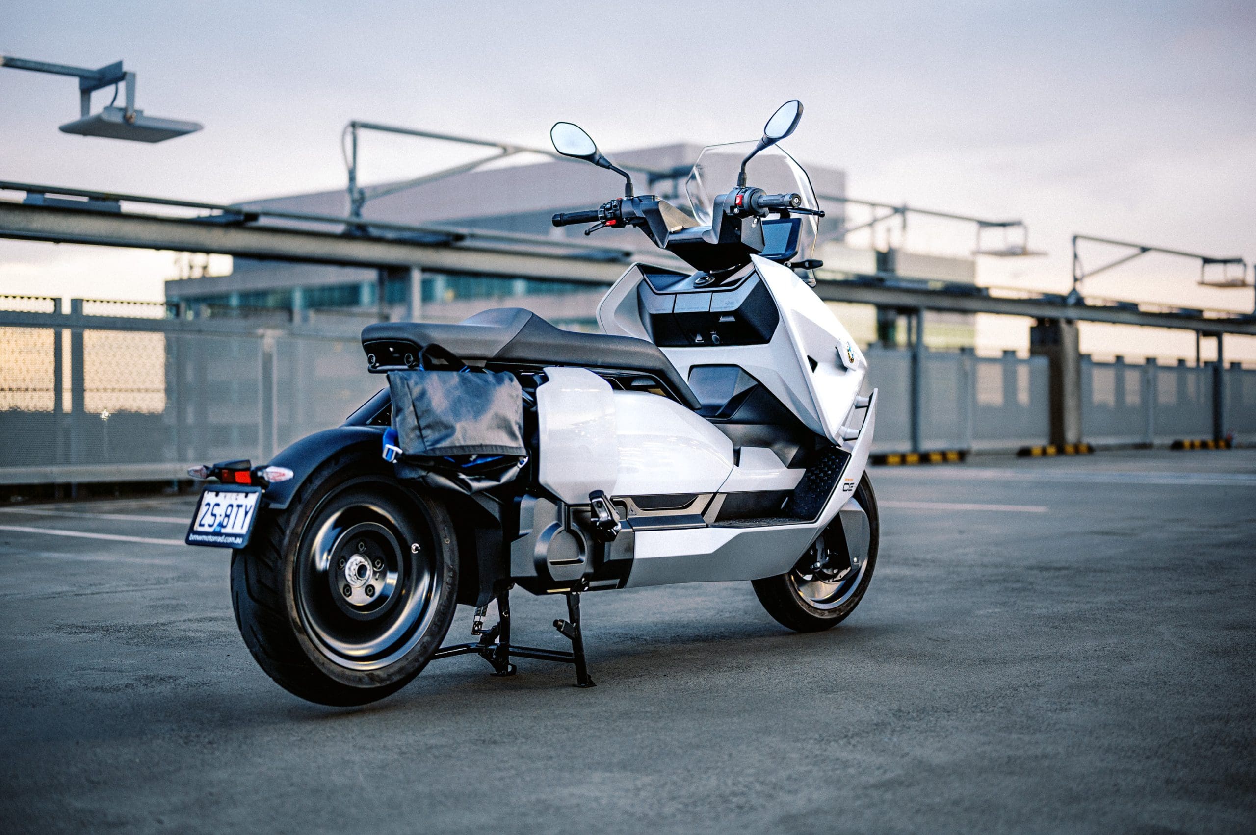 BMW's CE-04 electric scooter on a carpark rooftop at sunset