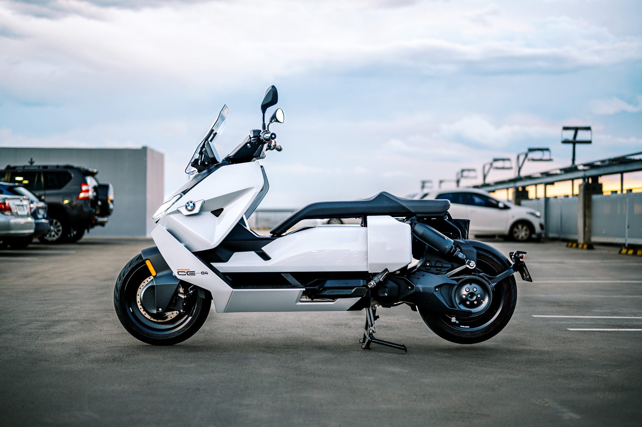 BMW's CE-04 electric scooter on a carpark rooftop at sunset