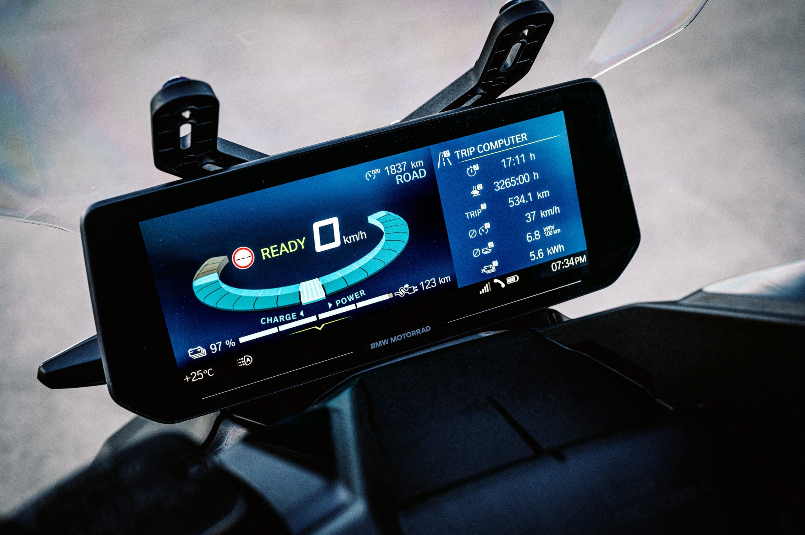 the screen of BMW's CE-04 electric scooter on a carpark rooftop at sunset
