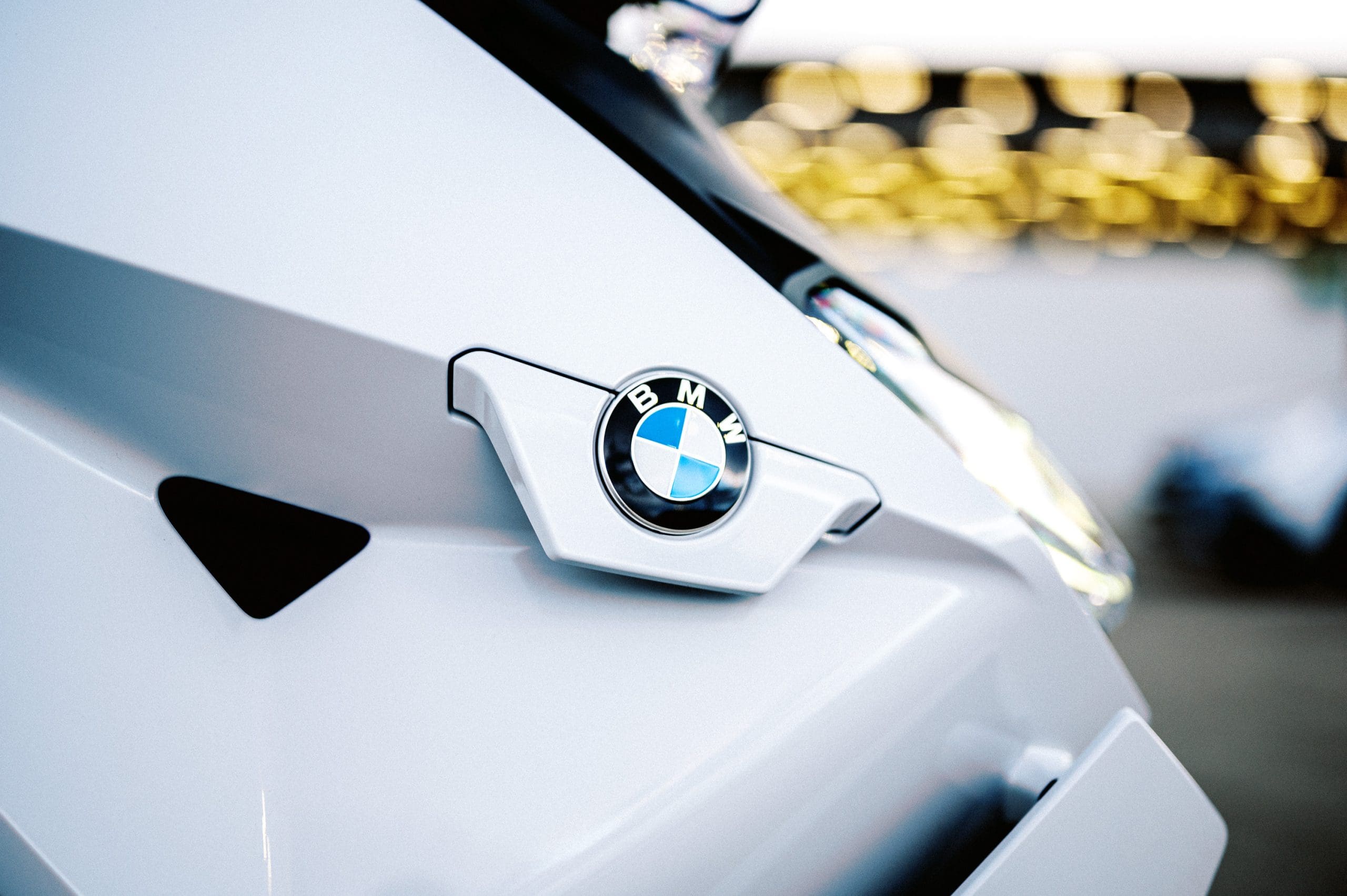 the nose of BMW's CE-04 electric scooter on a carpark rooftop at sunset