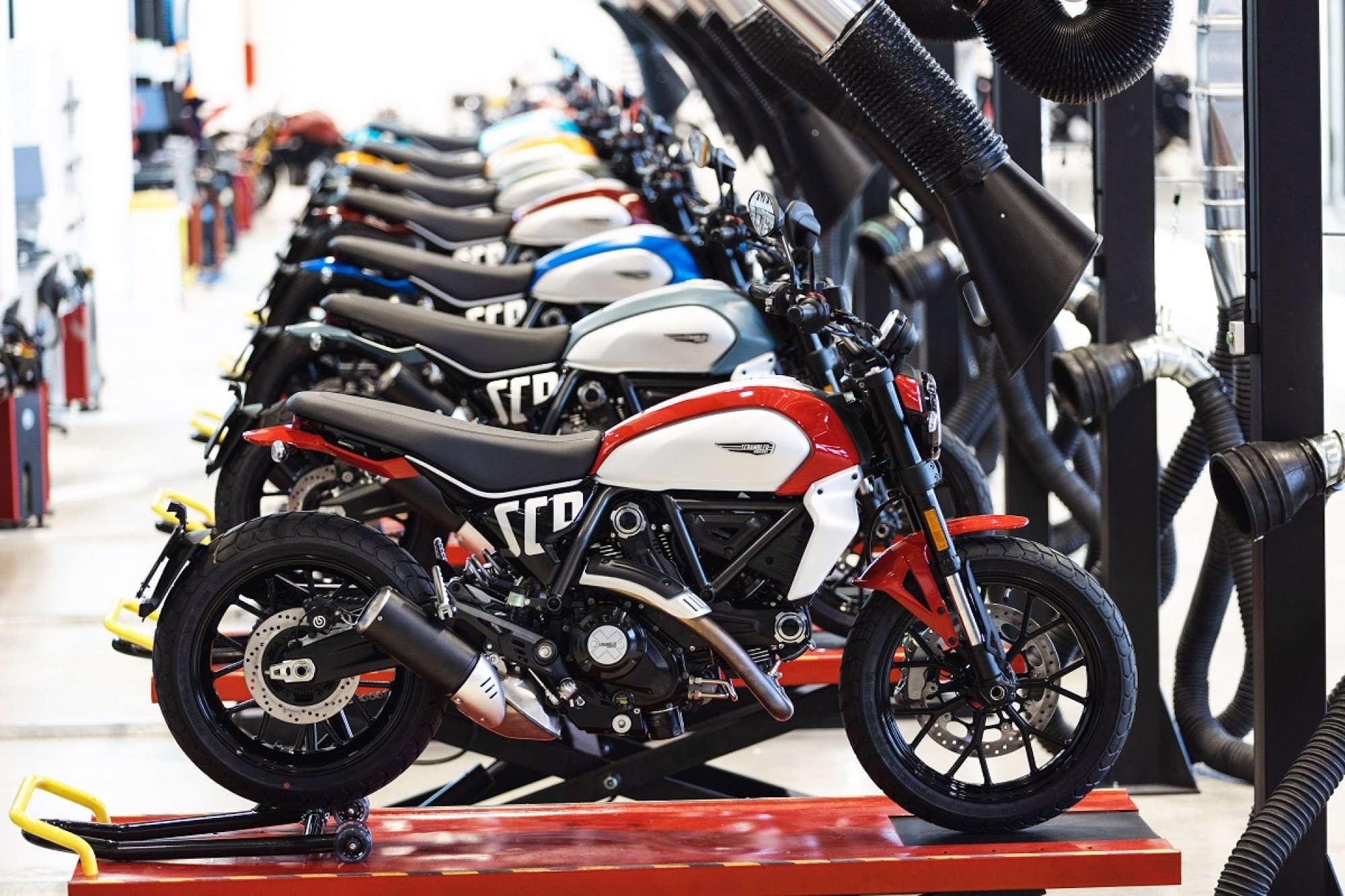 A view of Ducati's new Scramblers, which begin production in Ducati’s new eco-friendly building (the Finitura and Delibera Estetica). Media sourced from Motorcycle Sports.