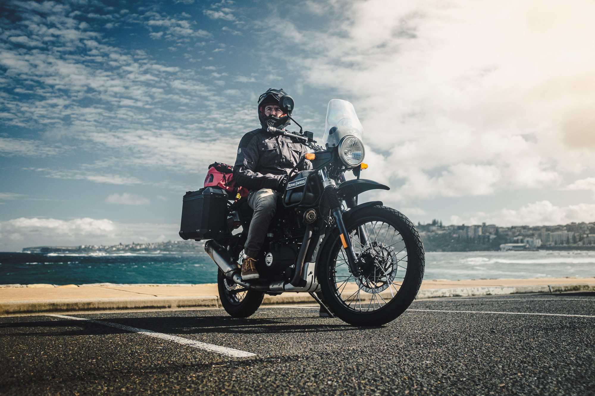Daniel 'Beardy' McLaughlin on a Royal Enfield Himalayan at Bondi Beach
