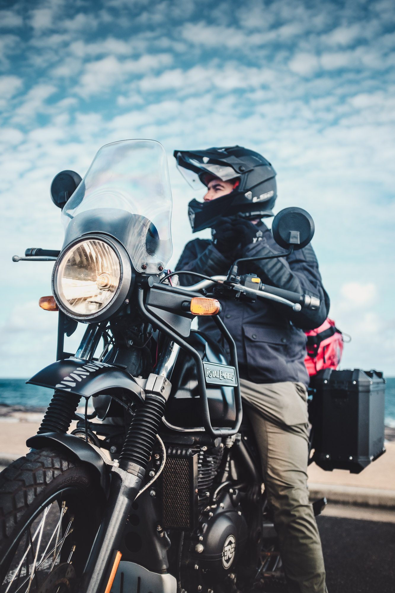 Daniel 'Beardy' McLaughlin on a Royal Enfield Himalayan at Bondi Beach