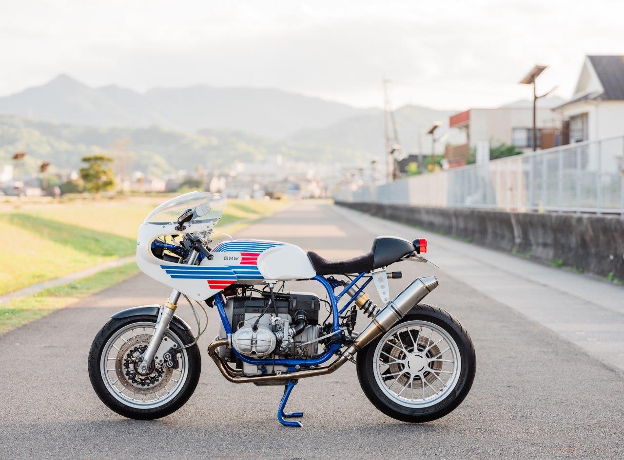 Retro BMW Racing Motorcycle on a footpath at sunset