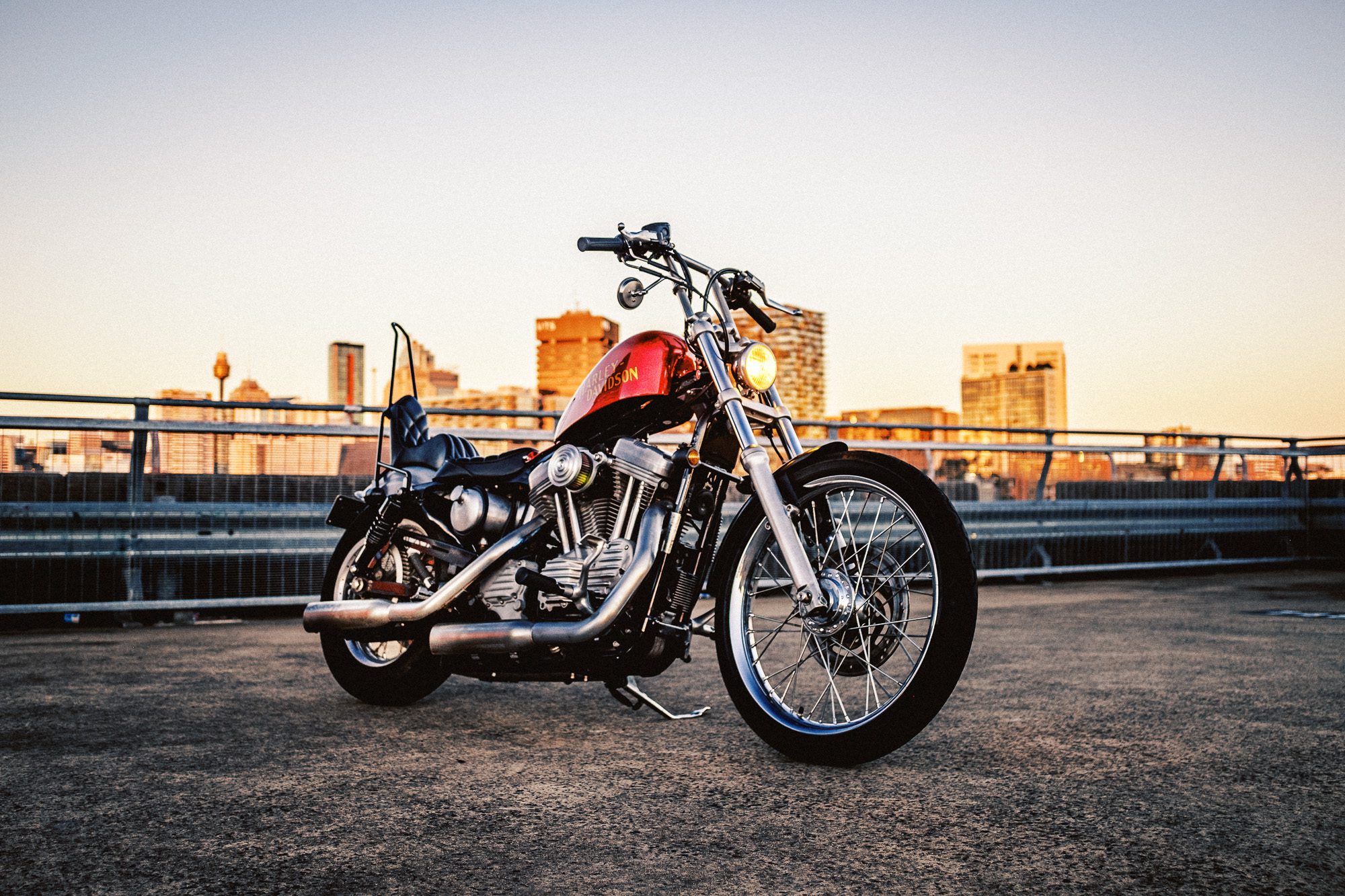 Right side view of custom Harley-Davidson XLH chopper on Sydney rooftop at sunset