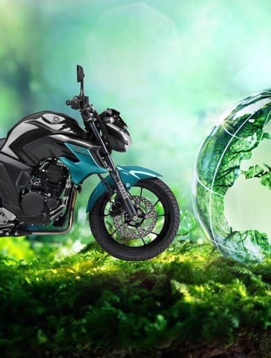 A view of Yamaha's 2019 FZ25 next to a globe representing sustainability. Media sourced from TWI Global and Yamaha Motorcycles.