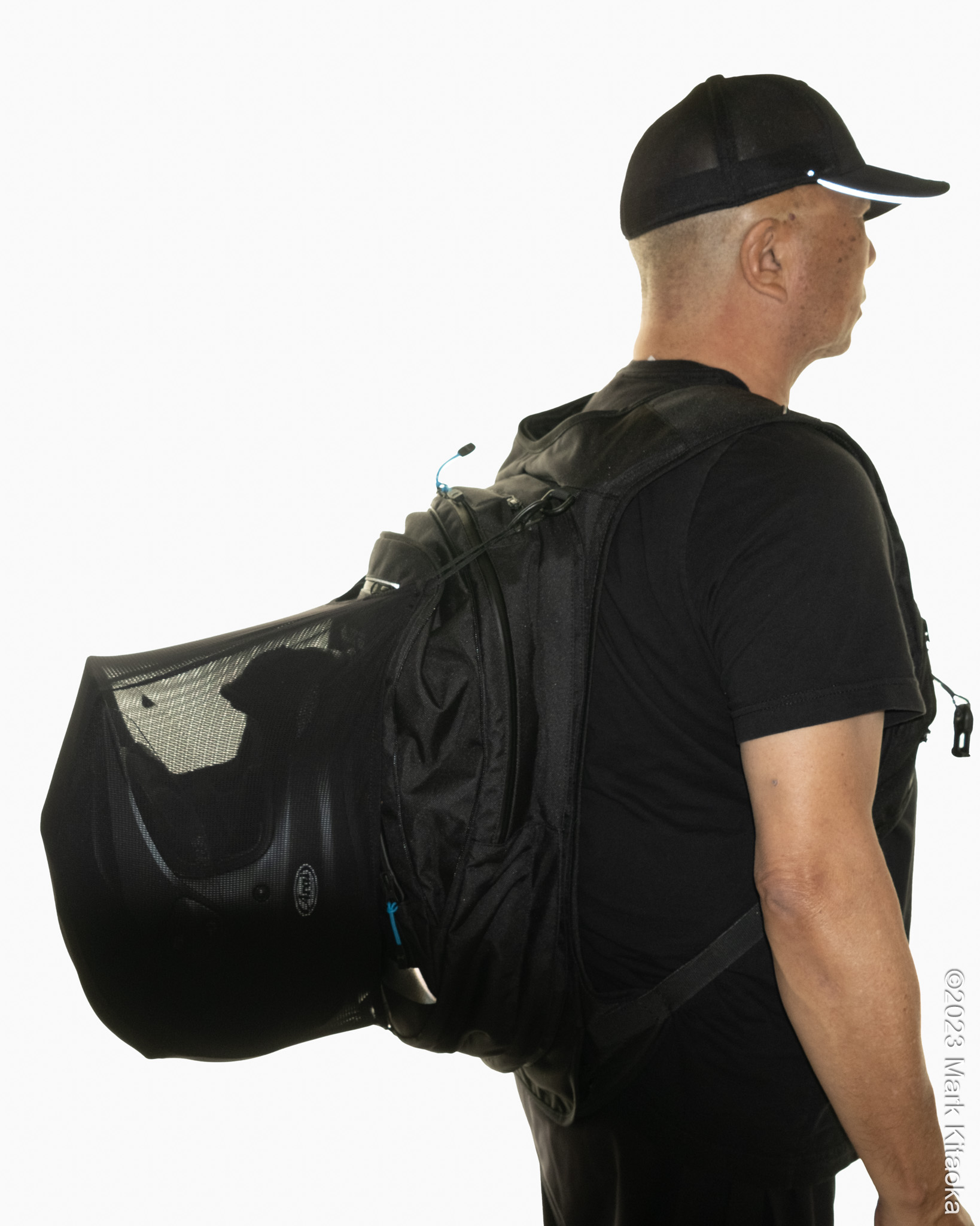Side profile of a helmet being carried on the H-MOOV airbag backpack