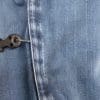 Trigger tether hanging outside of the jeans