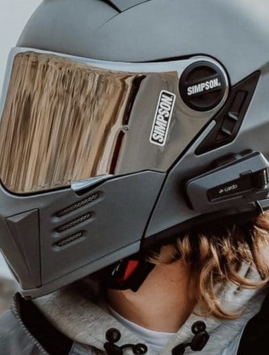 A view of a motorcycle rider using a Cardo System comm device. Media sourced from Cardo Systems.