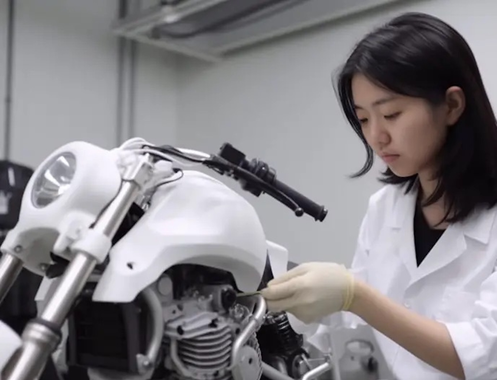 An employee working on a motorcycle, representative of the new things HySE plans on doing with hydrogen cell-fuelled bikes. Media sourced from Paddock GP.