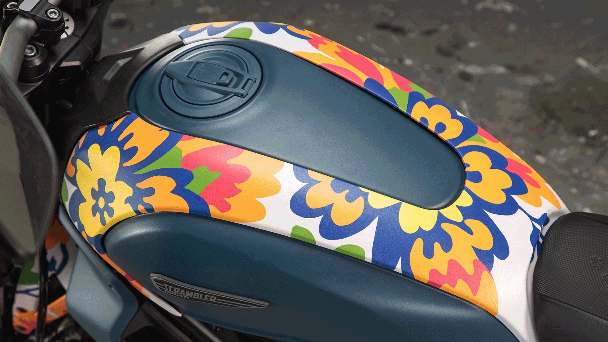 A view of Ducati's next-gen Scrambler Icon - a bike that's recently had a new livery scheme from RXART artist Mickalene Thomas, in support of art in children's hospitals. Media sourced from Ducati.