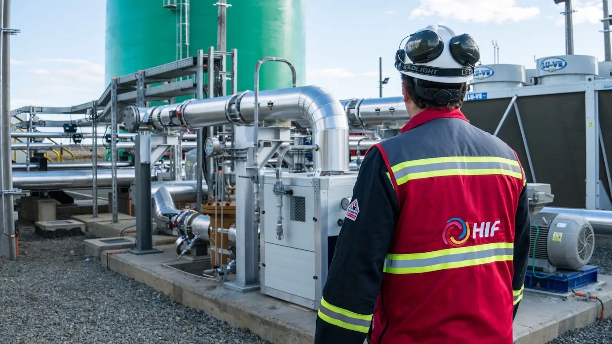 An HIF worker facing a series of machinery used in the creation of e-fuel. Media sourced from The Drive.