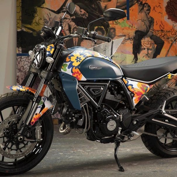 A view of Ducati's next-gen Scrambler Icon - a bike that's recently had a new livery scheme from RXART artist Mickalene Thomas, in support of art in children's hospitals. Media sourced from Ducati.