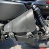 Closeup photo of the swingarm bag and dual leather straps secured