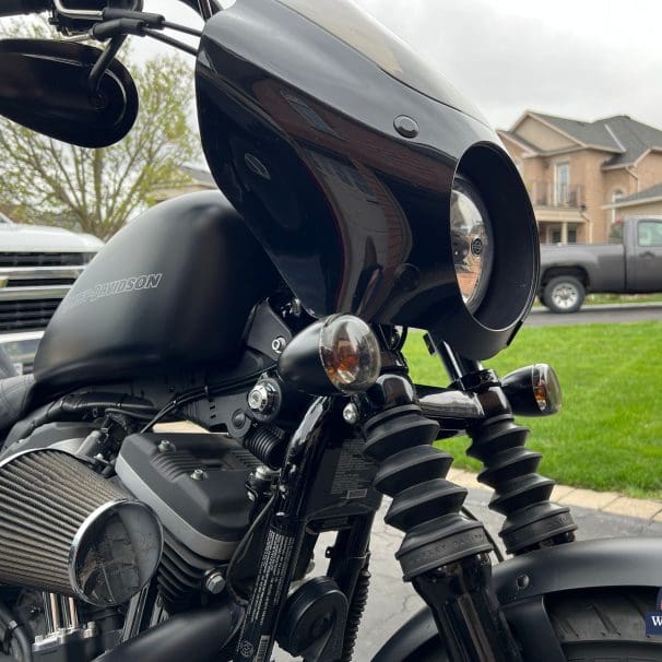 Close up side profile of the fairing & turn signal relocation kit installed on motorcycle