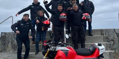 A view of the Acerbis team and their Honda Monkey, featuring a massive gas tank. Media sourced from Superbike News.