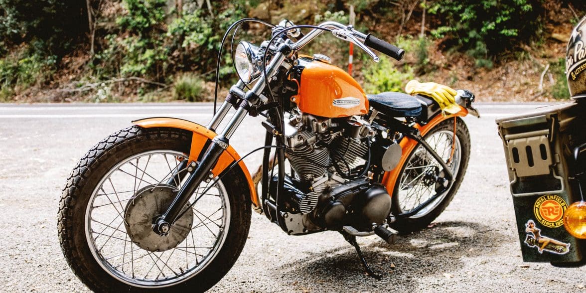A classic Harley-Davidson Sportster motorcycle from the 1960s is park by the side of the road in Sydney, Australia