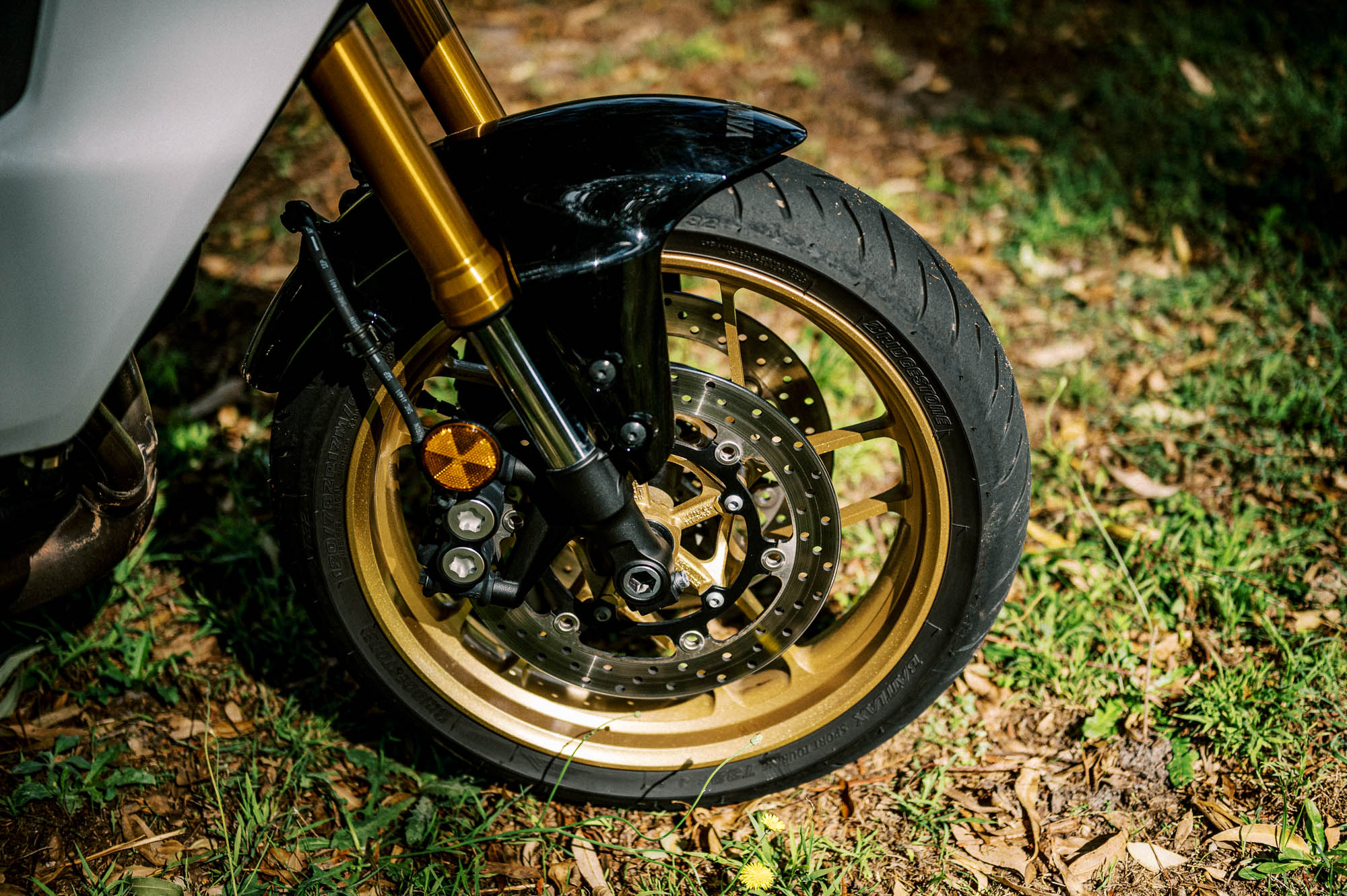 A detail shot of a 2023 Yamaha Tracer 9 GT Motorcycle in a Sydney Park