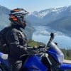 Rider wearing LS2 Explorer Carbon Helmet with mountains in the background