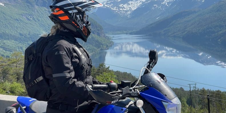 Rider wearing LS2 Explorer Carbon Helmet and Serra Evo jacket
