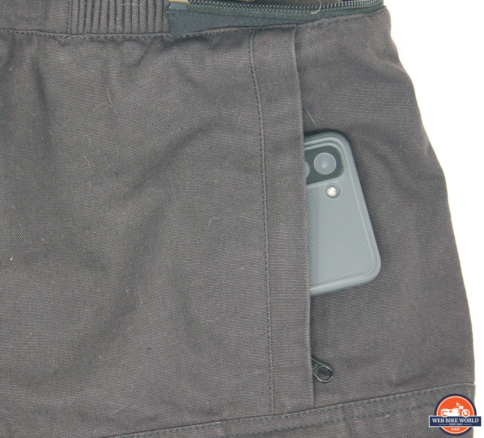 Closeup of a smartphone in the front left pocket