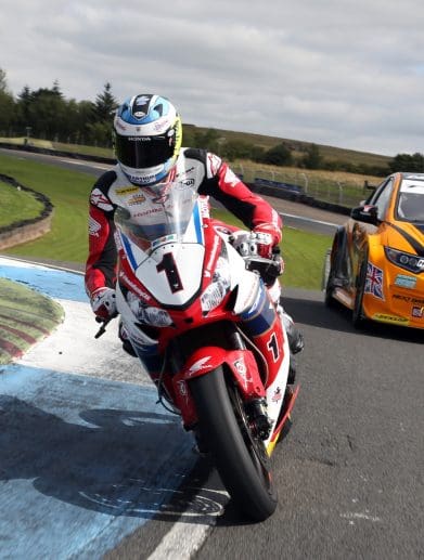 motorcycle and racecar on track