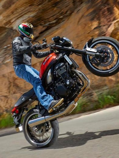 A motorcyclists performs a wheelie on a motorcycle