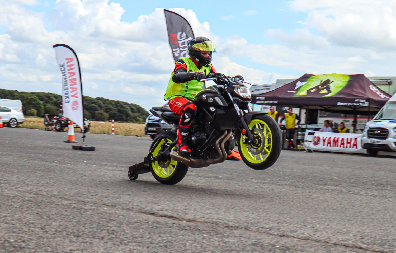 A motorcyclist performs a wheelie on a motorcycle
