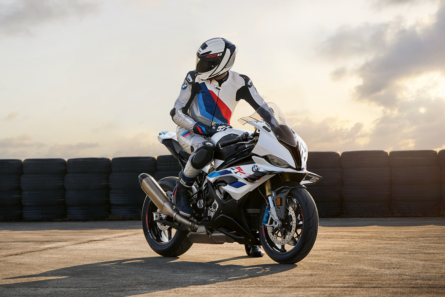 A 2023 BMW S 1000 RR motorcycle with a rider at a racetrack