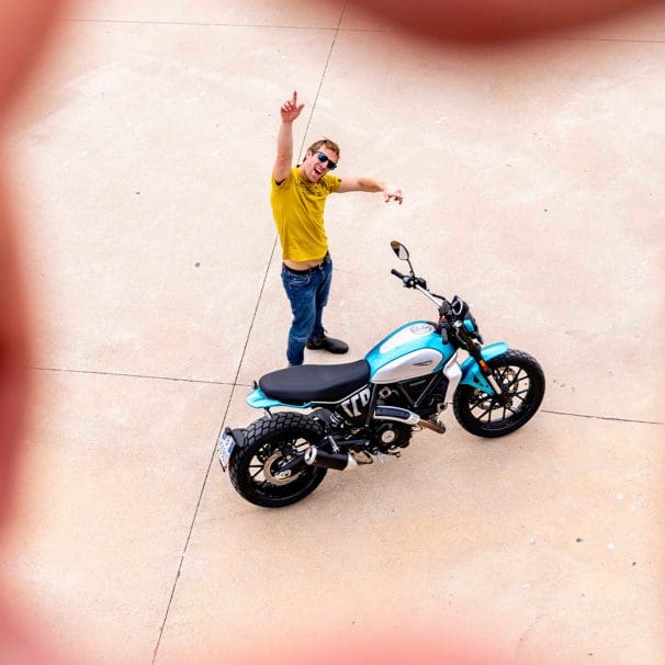 A model next to a Ducati Scrambler. Media sourced from Ducati.