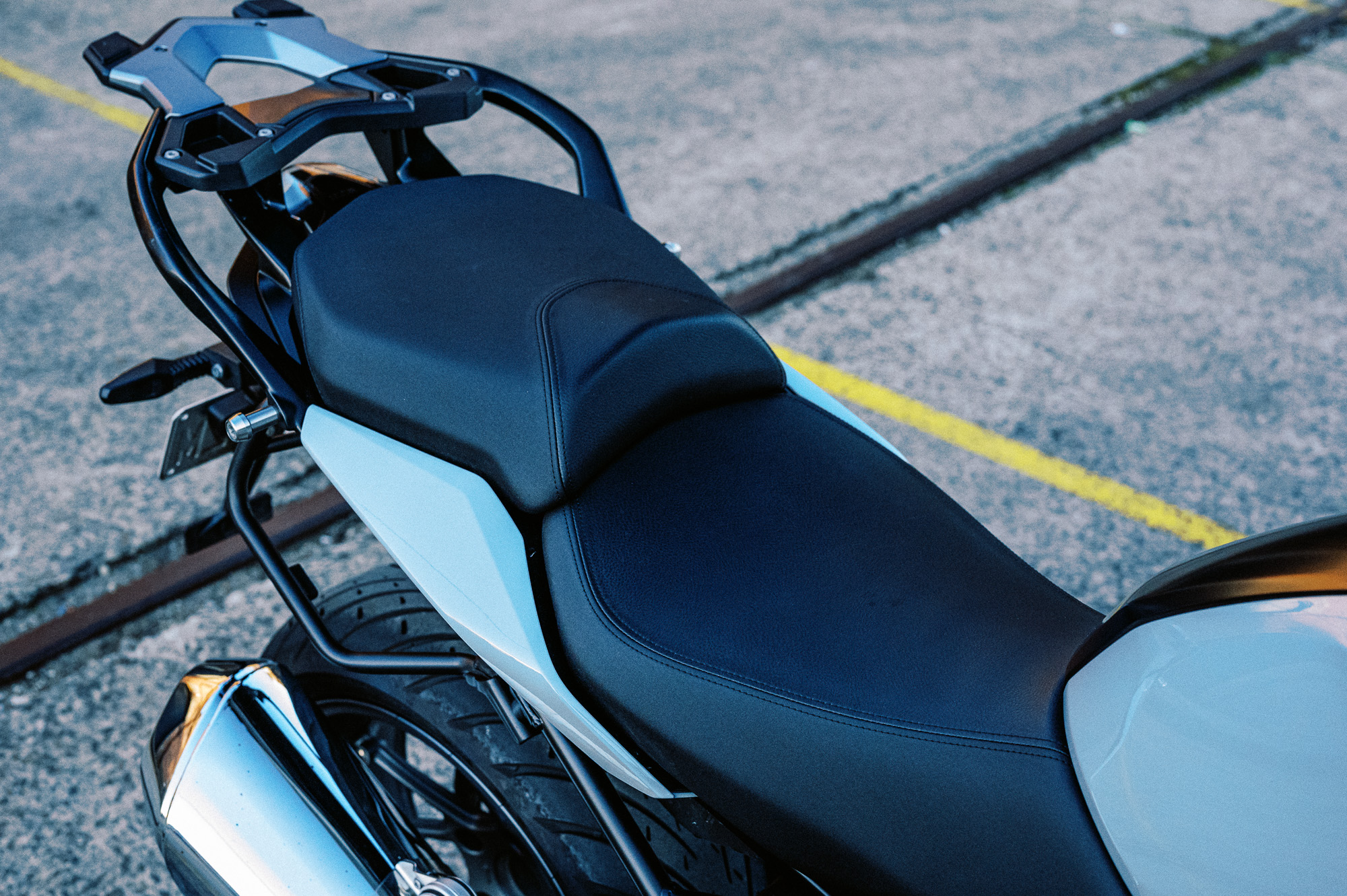a detail photo of a 2023 BMW R 1250 R motorcycle at dusk in an old train carriage works