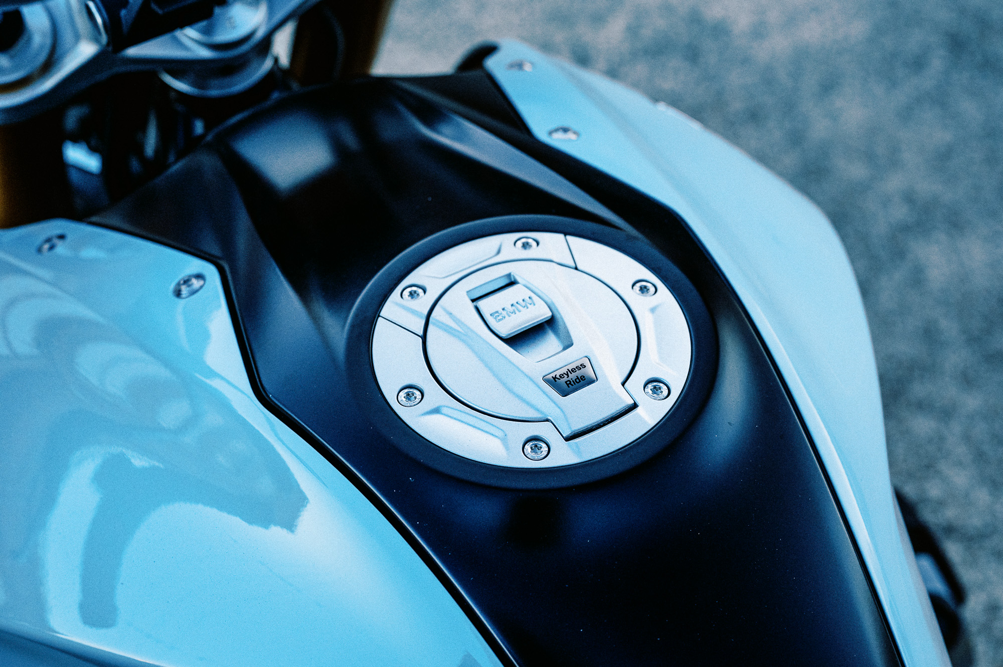 a detail photo of a 2023 BMW R 1250 R motorcycle at dusk in an old train carriage works