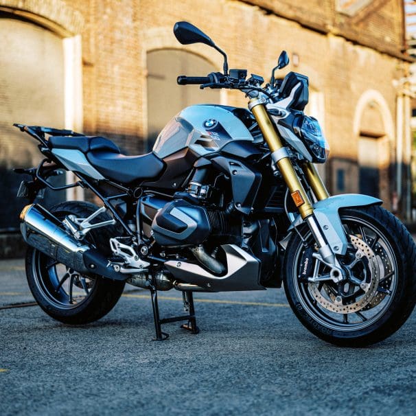 photo of a 2023 BMW R 1250 R motorcycle at dusk in an old train carrigeworks