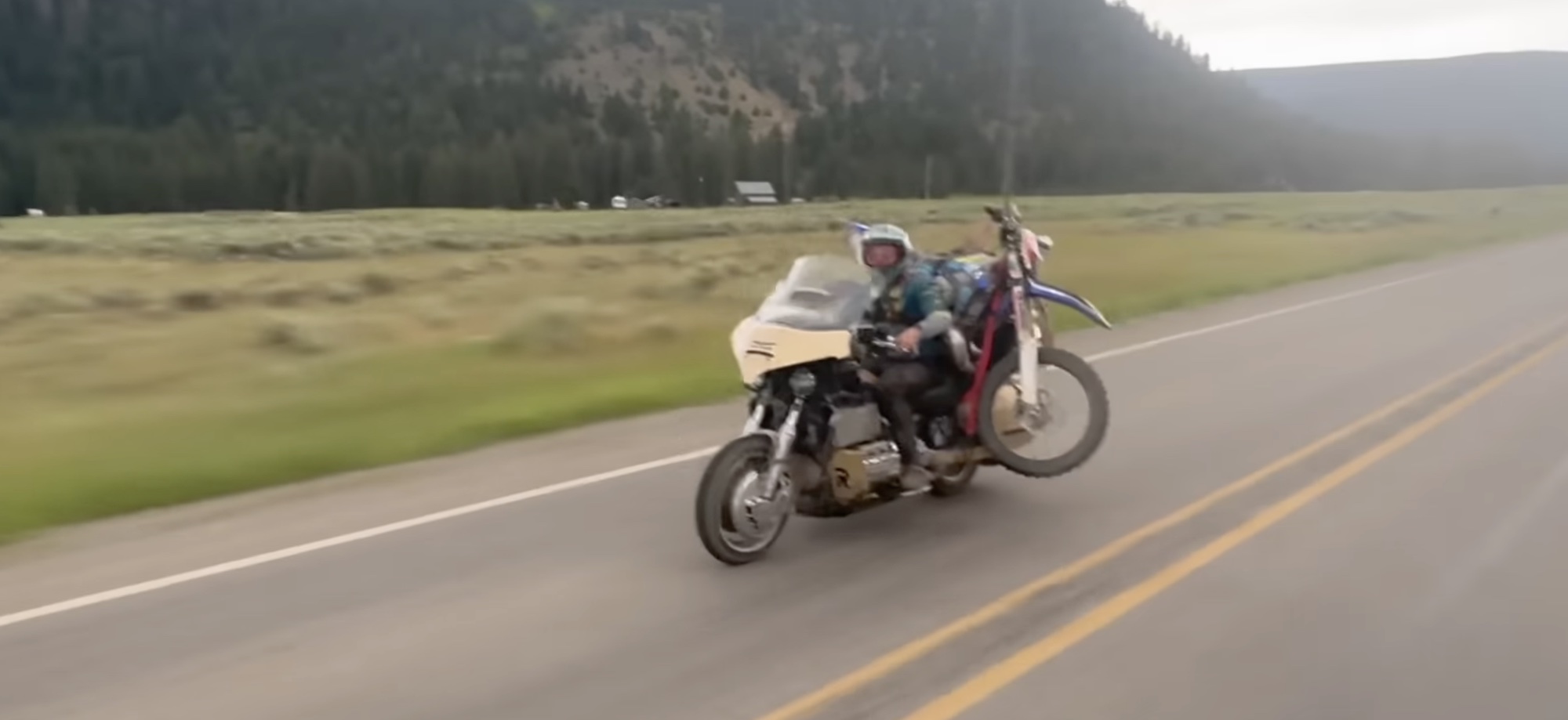 A view of a modded Honda Gold Wing off-roading a dirt bike to a local hilltop. Media sourced from Youtube.