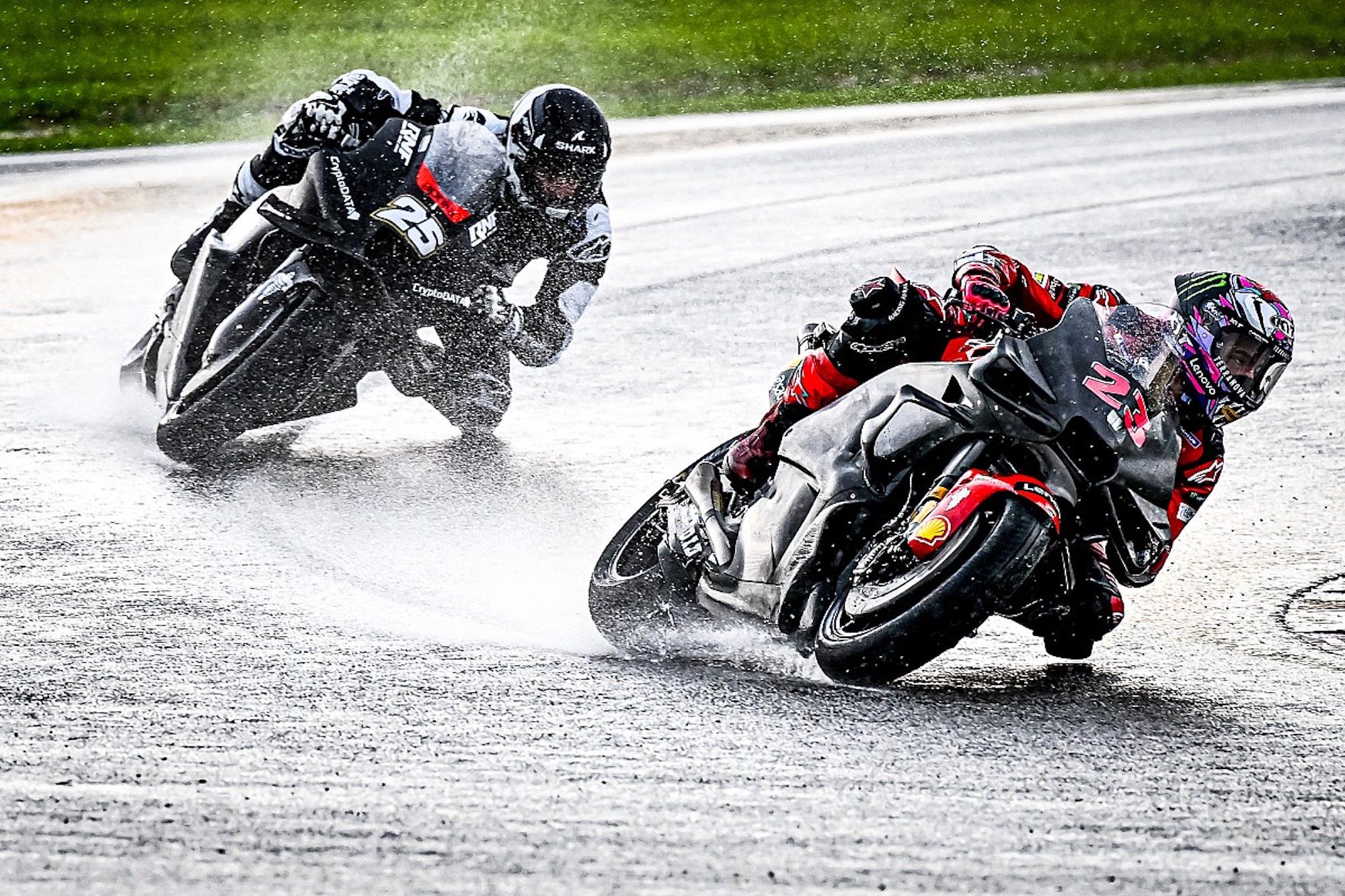 A pair of MotoGP racers showing excellent leaning techniques in rainy weather. Media sourced from Motorsport.