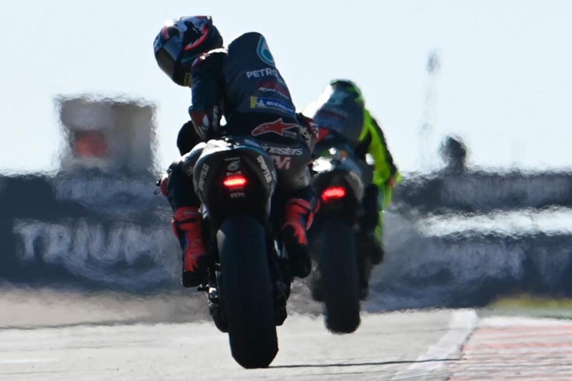 A MotoGP racer looking back at a photographer. Media sourced from Crash.