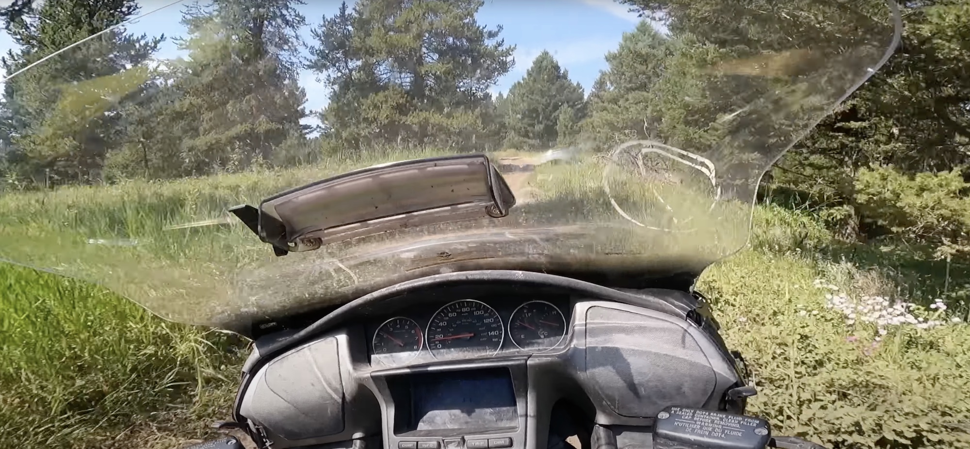 A view of a modded Honda Gold Wing off-roading a dirt bike to a local hilltop. Media sourced from Youtube.